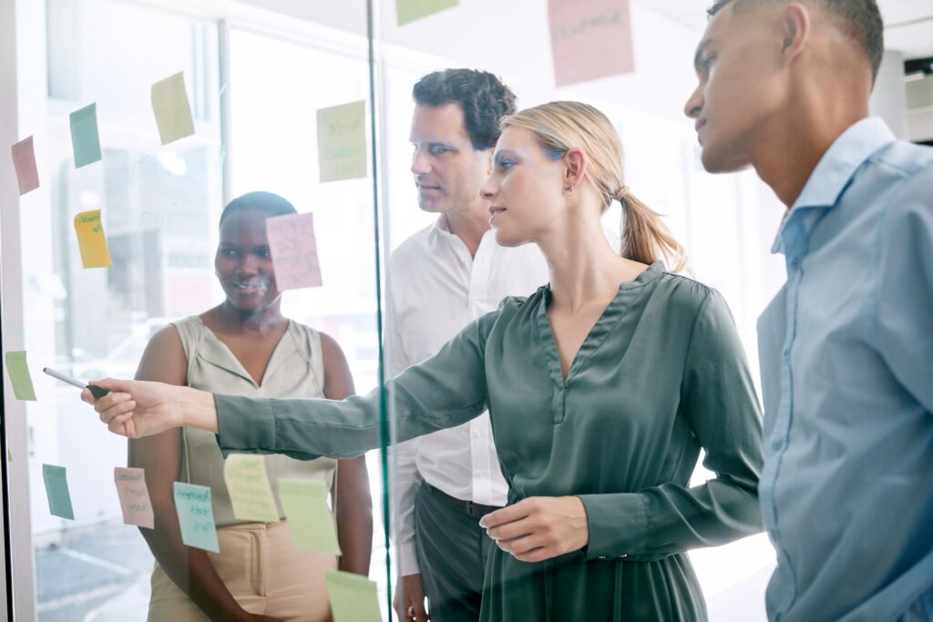 Corporate, sticky notes and business people planning a team mission, project or growth of business