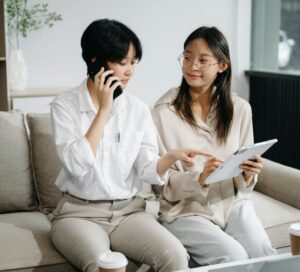 Two Asian businesswoman discuss investment project working and planning strategy